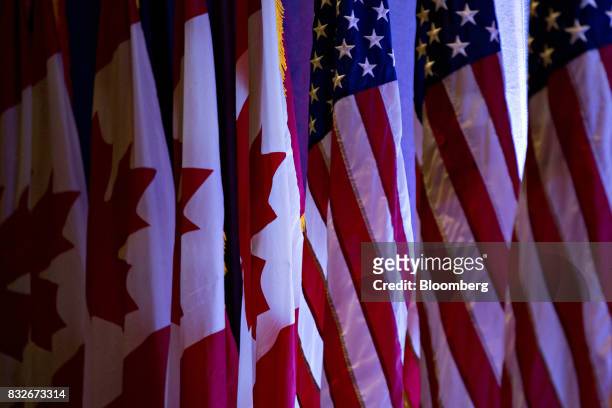 American flags, right, stand next to Canadian flags ahead of the first round of North American Free Trade Agreement renegotiations in Washington,...