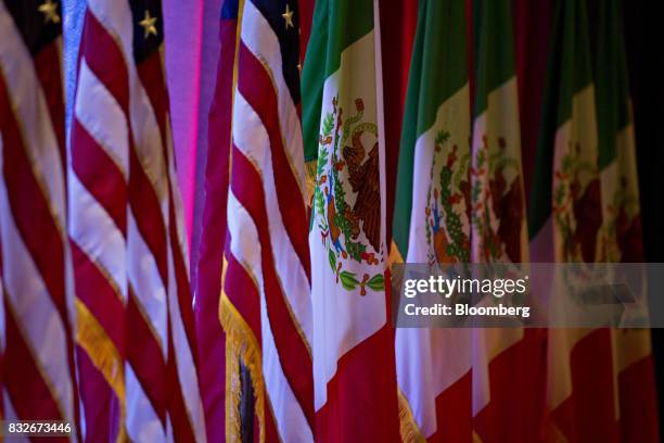 American flags, left, stand next to Mexican flags ahead of the first round of North American Free Trade Agreement renegotiations in Washington, D.C.,...