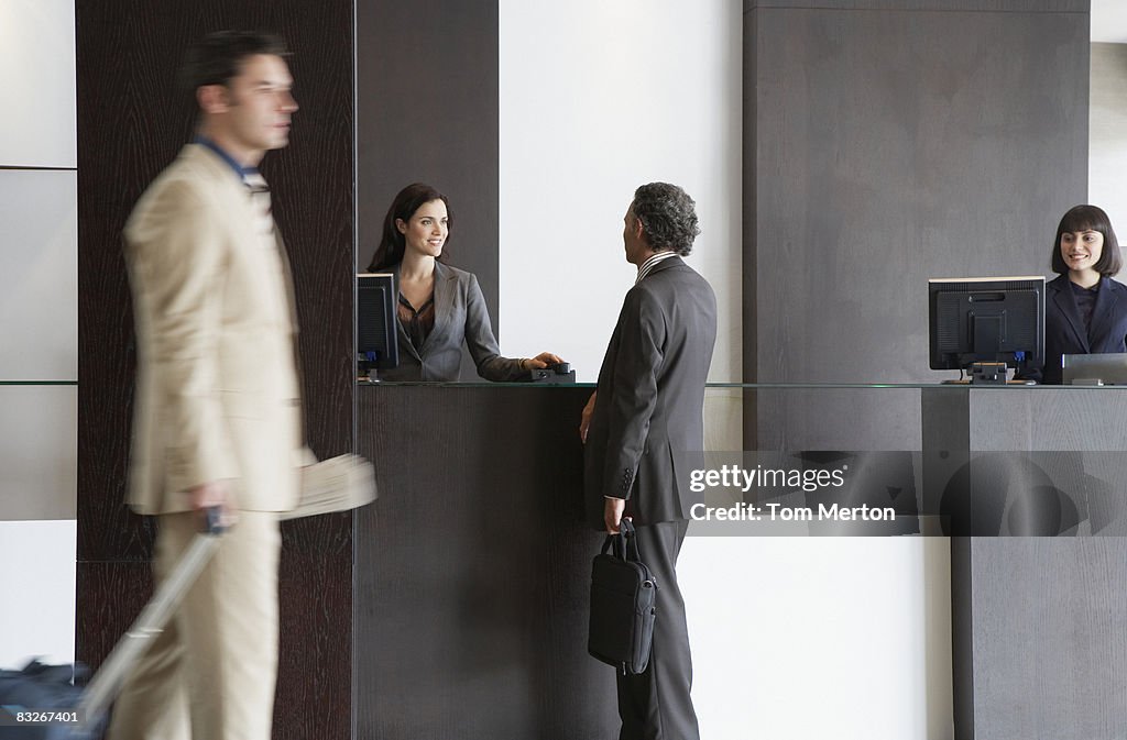 Customer service representative helping businessman