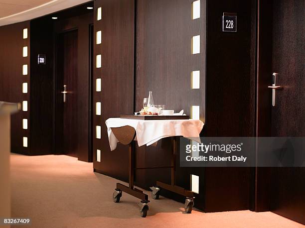 discarded room service dishes in hotel corridor - roomservice stockfoto's en -beelden
