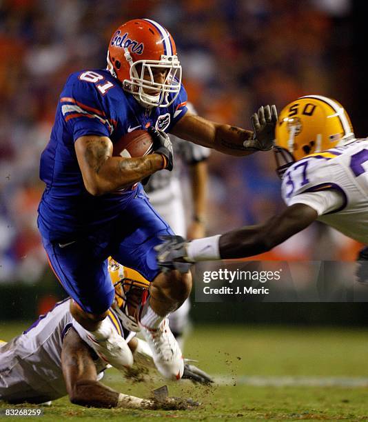 Tightend Aaron Hernandez of the Florida Gators is tackled by safety Karnell Hatcher of the LSU Tigers during the game on October 11, 2008 at Ben Hill...