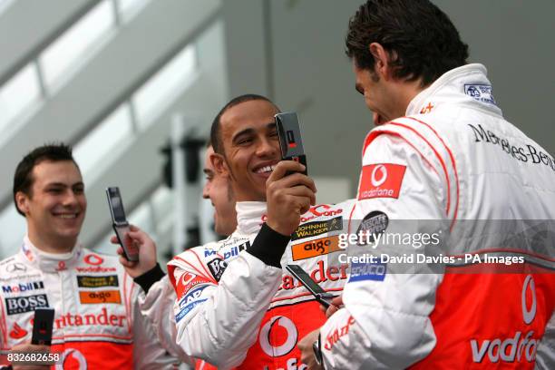 Vodafone McLaren Mercedes driver Lewis Hamilton of Great Britain holding a mobile phone during the photocall of the 2007 Vodafone McLaren Mercedes...
