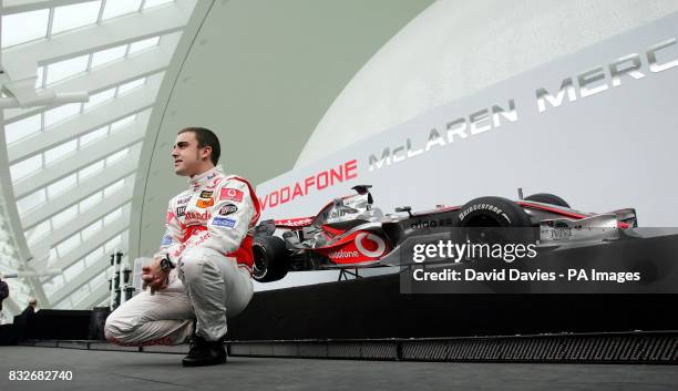 McLaren Mercedes driver World Champion Fernando Alonso poses with the new McLaren MP4-22 Formula One car during the launch in L'Hemisferic, Ciudad de...