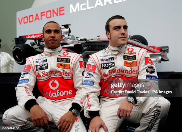 Vodafone McLaren Mercedes drivers Lewis Hamilton of Great Britain, and World Champion Fernando Alonso of Spain , pose with the new McLaren MP4-22...