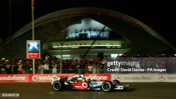 Lewis Hamilton drives his Vodafone McLaren Mercedes around the streets of Valencia during it's launch in L'Hemisferic, Ciudad de las Artes y de las...