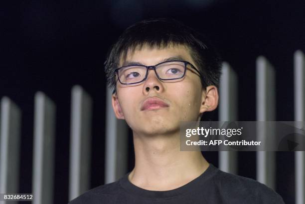 Joshua Wong, who became the face of Hong Kong's huge Umbrella Movement, waits to speaks as he attends a rally outside the government headquarters in...