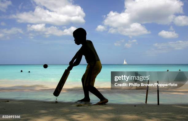 Young boy playing beach cricket on Batts Rock beach in Barbados during the ICC Cricket World Cup, 22nd April 2007.