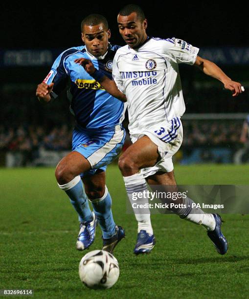 Wycombe Wanderers' Jermaine Easter and Chelsea's Ashley Cole battle for the ball during the Carling Cup semi-final first leg match at Causeway...