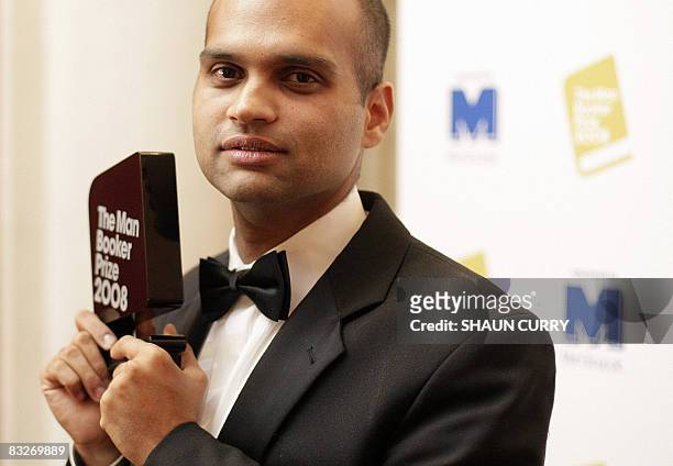 Indian writer Aravind Adiga poses with the 2008 Booker Prize after receiving the award for his book "The White Tiger" in London, on October 14, 2008....