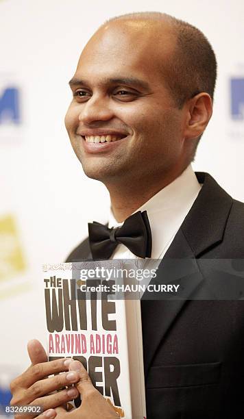 Indian writer Aravind Adiga poses with his book "The White Tiger" after receiving the 2008 Booker Prize in London, on October 14, 2008. Chairman of...