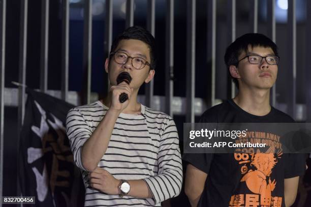 Joshua Wong , who became the face of Hong Kong's huge Umbrella Movement, listens as fellow pro-democracy activist and former legislator Nathan Law...