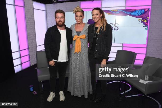 Pink poses with presenters Tom Green and Charlie Tee as she visits the Kiss FM Studios on August 16, 2017 in London, England.