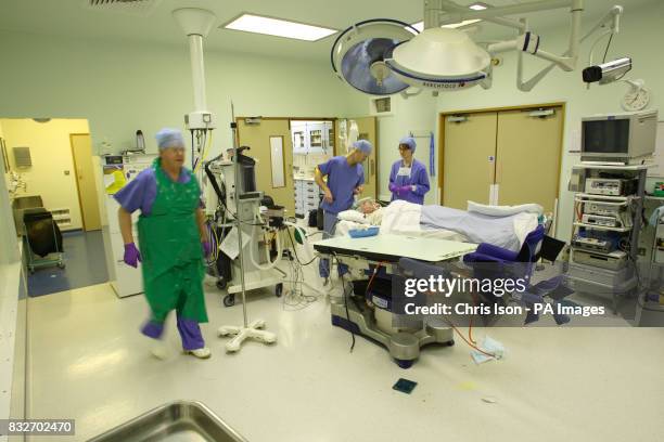 Operating Theatre staff prepare the theatre for the next procedure as the last patient comes round after a Laparoscopic Anterior Resection at the...