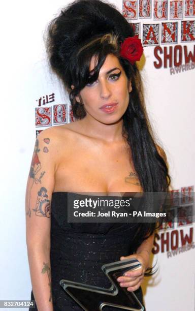 Amy Winehouse receives the Pop Award for her album Back To Black, during the South Bank Show Awards at the Savoy Hotel in central London.