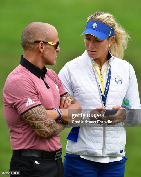 Suzann Pettersen of Team Europe talks with her personnal trainer during practice for The Solheim Cup at the Des Moines Country Club on August 16,...