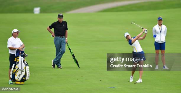 Jodi Ewart Shadoff of Team Europe plays a shot whilst being watched by coach David Leadbetter and Suzann Pettersen during practice for The Solheim...