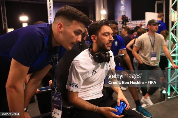 Tassal "Tass" Rushan of England speaks with his coach in his game against Rafael "Rafifa 13" Fortes of Brazil during day one of the FIFA Interactive...