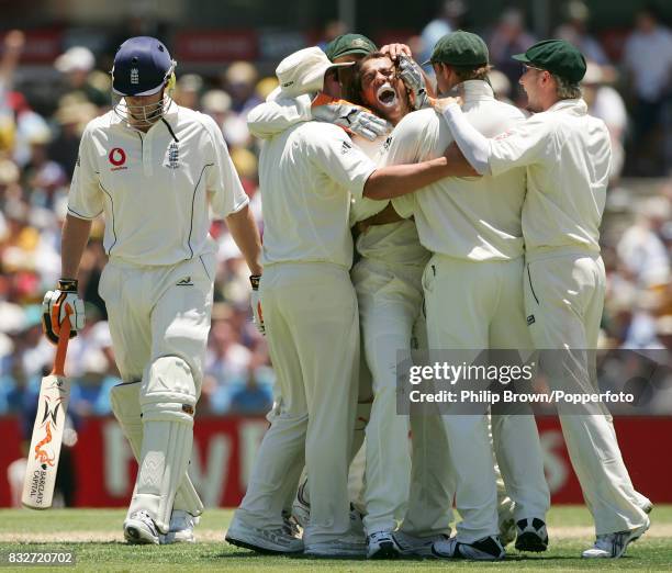 Andrew Symonds of Australia is congratulated by team-mates after getting the wicket of England captain Andrew Flintoff on day two of the 3rd Test...