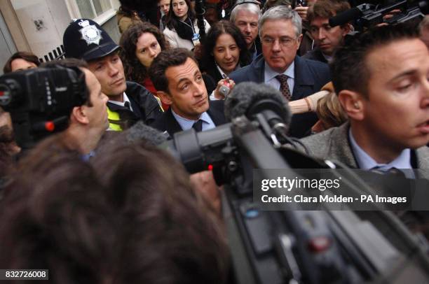 Leader of the UMP Party Nicolas Sarkozy tries to walk through media towards his car after leaving the Job Centre Plus in Marylebone, London.