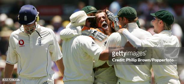 Andrew Symonds of Australia is congratulated by team-mates after getting the wicket of England captain Andrew Flintoff on day two of the 3rd Test...
