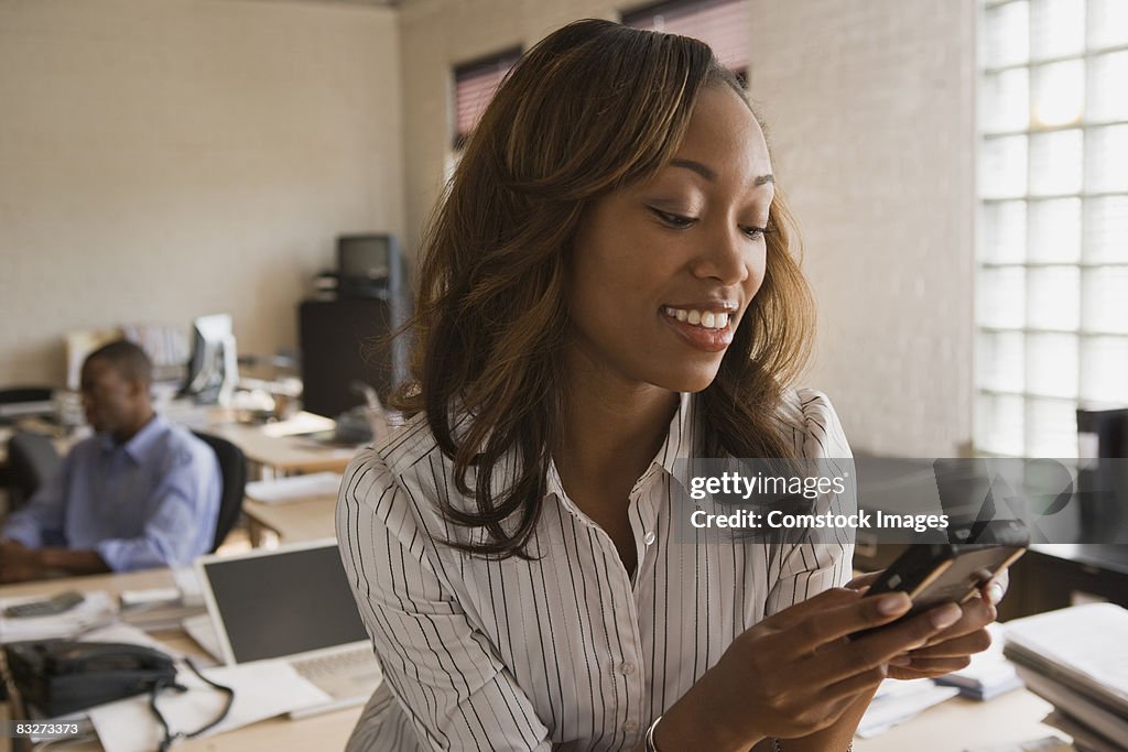 Woman text messaging on cellular phone