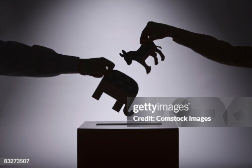 People putting political symbols in box People putting political symbols in box