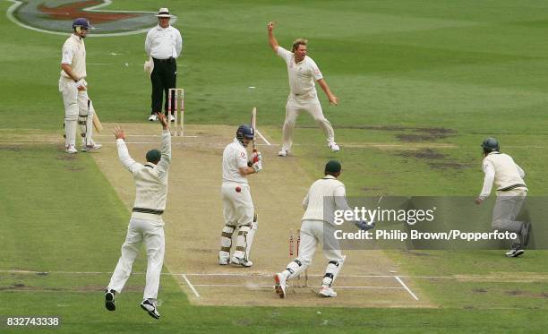 Shane Warne of Australia celebrates bowling England batsman Andrew Strauss to reach 700 Test wickets during the 4th Test match between Australia and...