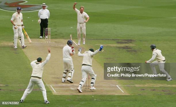 Shane Warne of Australia celebrates bowling England batsman Andrew Strauss to reach 700 Test wickets during the 4th Test match between Australia and...