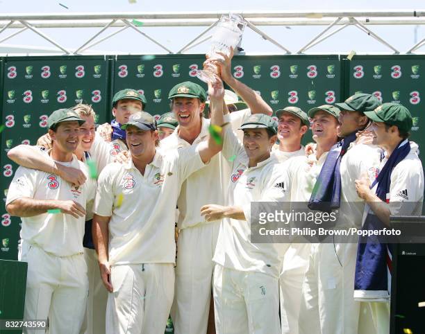 Shane Warne, Glenn McGrath, and Justin Langer of Australia, at the end of their last Test match for Australia, lift the crystal Ashes urn after...