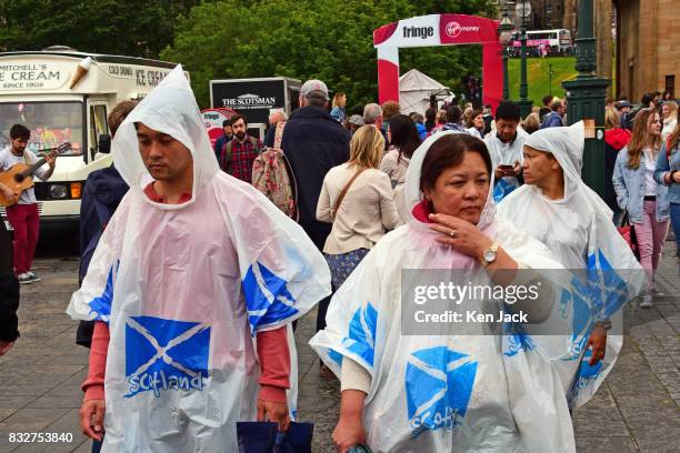 Fringe-goers in ponchos brave the rain during the Edinburgh Festival Fringe, on August 16, 2017 in Edinburgh, Scotland. The Fringe is celebrating its...