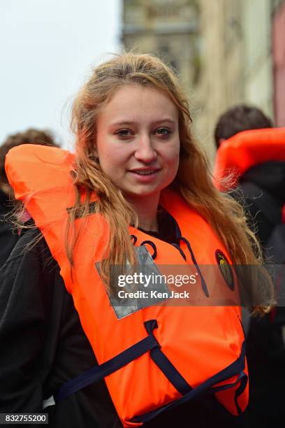 Actor Issy Crutchley wears a lifejacket on the Royal Mile during the Edinburgh Festival Fringe, to promote a show "The Runner" which tells the story...