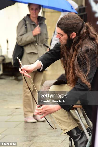 Street performer plays a saw during the Edinburgh Festival Fringe, on August 16, 2017 in Edinburgh, Scotland. The Fringe is celebrating its 70th...