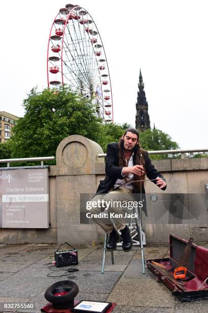 Street performer plays a saw during the Edinburgh Festival Fringe, on August 16, 2017 in Edinburgh, Scotland. The Fringe is celebrating its 70th...