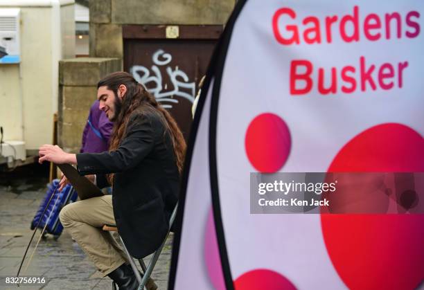 Street performer plays a saw during the Edinburgh Festival Fringe, on August 16, 2017 in Edinburgh, Scotland. The Fringe is celebrating its 70th...