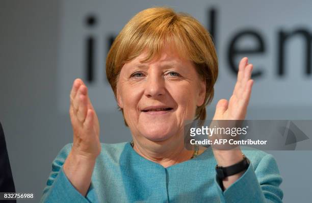 German Chancellor Angela Merkel applauds during an election campaign rally of the Christian Democratic Union in Heilbronn, southern Germany on August...