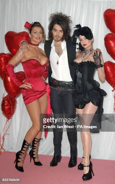 Russell Brand with burlesque dancers Valerie and Valeria at a photocall to launch this years Brit Awards, at Earls Court in west London.