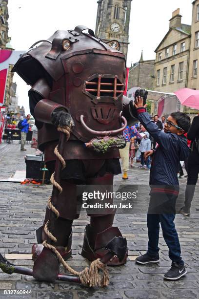 Performer on the Royal Mile gives a young boy a "high five" during the Edinburgh Festival Fringe, on August 16, 2017 in Edinburgh, Scotland. The...