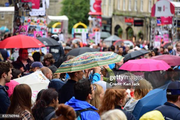 Fringe-goers under umbrellas brave the rain during the Edinburgh Festival Fringe, on August 16, 2017 in Edinburgh, Scotland. The Fringe is...