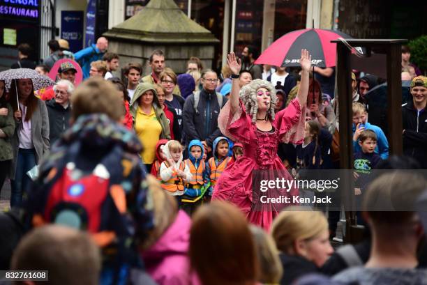 Fringe-goers and performers brave the rain during the Edinburgh Festival Fringe, on August 16, 2017 in Edinburgh, Scotland. The Fringe is celebrating...