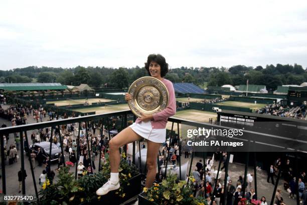 Virginia Wade of Britain with the trophy, presented to her by the Queen, after winning the Wimbledon women's singles championship for the first time...