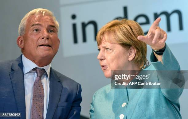 German Chancellor Angela Merkel talks with Thomas Strobl, co-chairman of the CDU during an election campaign rally of the Christian Democratic Union...