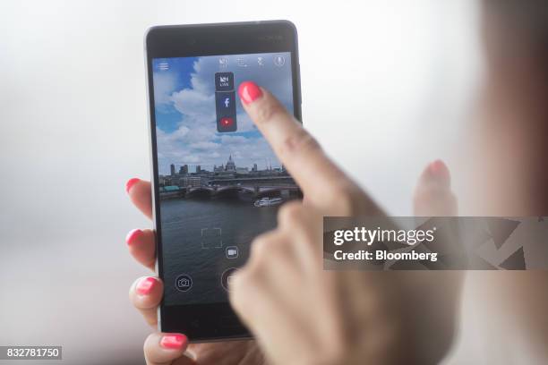 Worker demonstrates live filming capabilities of the Nokia 8 smartphone, designed by HMD Global Oy, ahead of its official unveiling in London, U.K.,...
