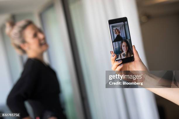 Workers demonstrate the front and rear cameras on the Nokia 8 smartphone, designed by HMD Global Oy, ahead of its official unveiling in London, U.K.,...