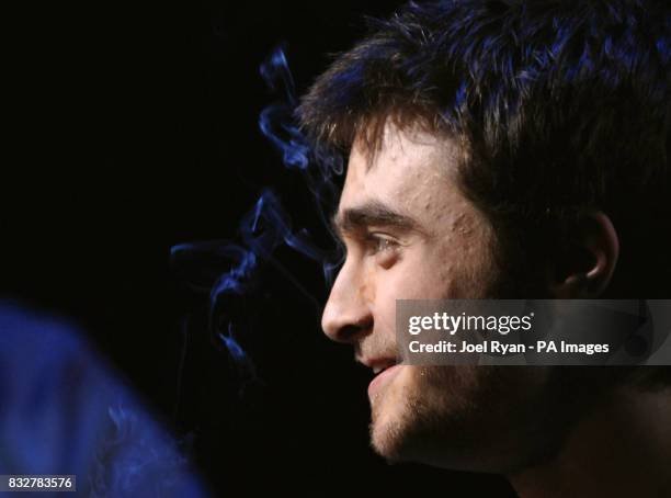 Daniel Radcliffe, with smoke from his cigarette in front of his eyes, during a photocall for the theatre production of Equus, at the Gielgud Theatre,...