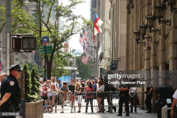 People watch as President Donald Trump's motorcade departs Trump Tower on August 16, 2017 in New York City. Trump is traveling to Bedminster, New...