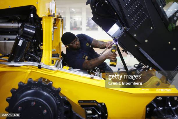 Worker assembles a skid steer loader construction vehicle at the JC Bamford Excavators LTD. Manufacturing plant in Pooler, Georgia, U.S., on Friday,...