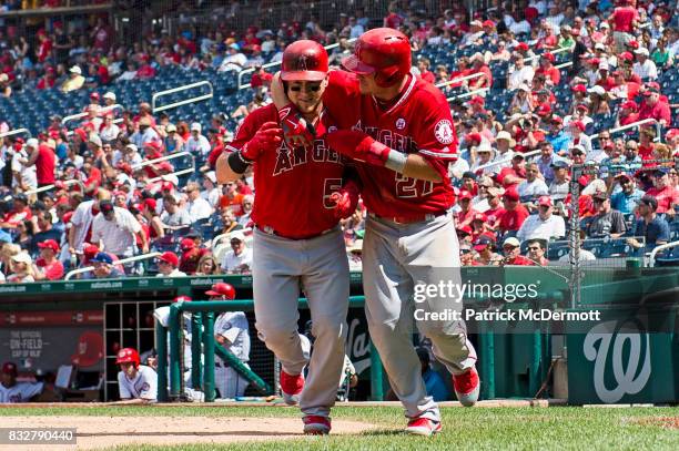 Kole Calhoun of the Los Angeles Angels of Anaheim celebrates with Mike Trout after hitting a two-run home run in the sixth inning during a game...