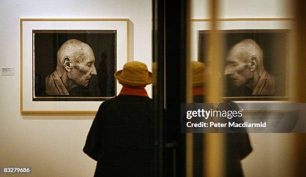 Visitor to the Annie Leibovitz: A Photographer's Life, 1990-2005 exhibition looks at a photograph of William S Burroughs at The National Portrait...