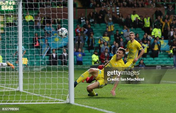 Evgeni Postnikov of FC Astana scores an own goal during the UEFA Champions League Qualifying Play-Offs Round First Leg match between Celtic FC and FK...