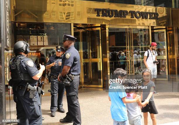 People walk outside of Trump Tower after it re-opened to the public following the departure of US President Donald Trump on August 16, 2017 in New...